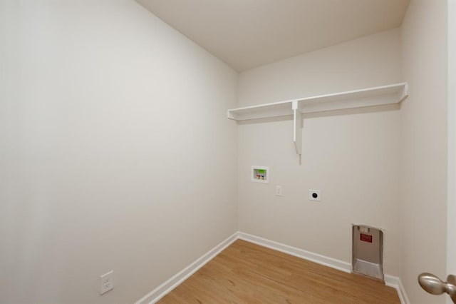 clothes washing area with light wood finished floors, laundry area, hookup for an electric dryer, hookup for a washing machine, and baseboards