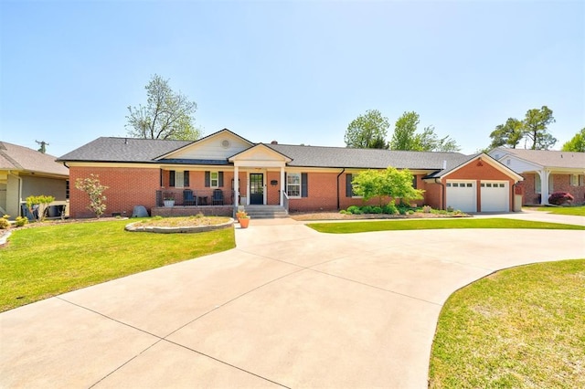 single story home with a porch, a garage, a front lawn, and driveway