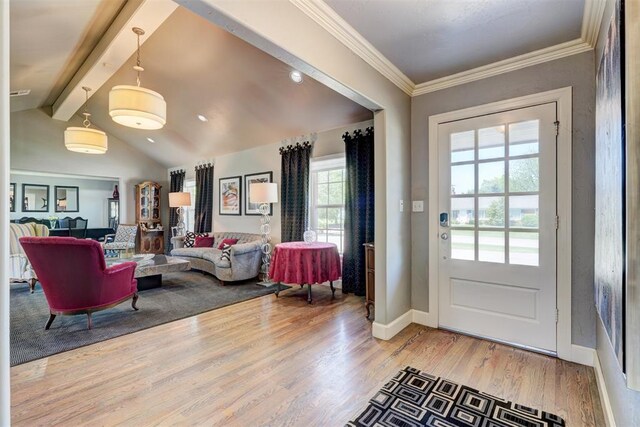 entryway with baseboards, lofted ceiling with beams, crown molding, and wood finished floors
