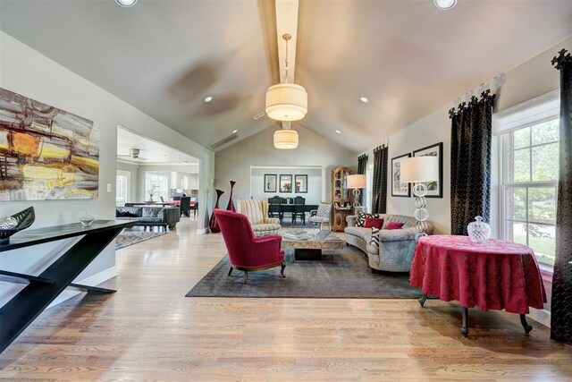 living room with vaulted ceiling with beams, recessed lighting, wood finished floors, and a healthy amount of sunlight