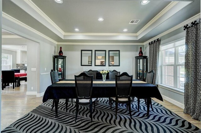 rec room with crown molding, baseboards, visible vents, and light wood finished floors