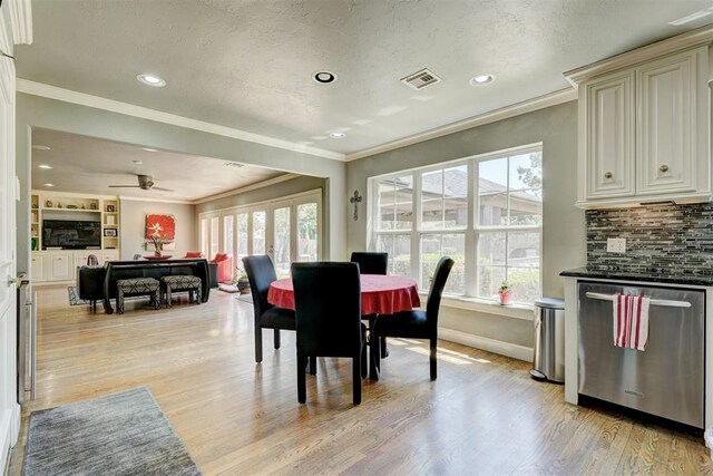 dining area featuring visible vents, plenty of natural light, and light wood-style flooring