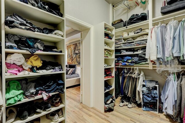 spacious closet featuring wood finished floors