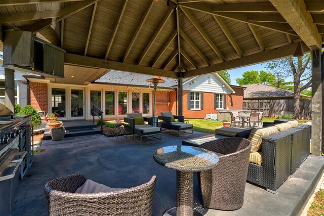 view of patio with outdoor dining area, outdoor lounge area, fence, and french doors