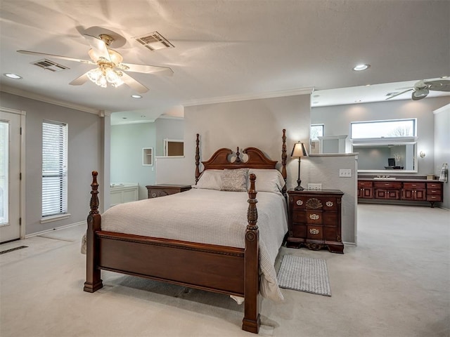bedroom featuring light colored carpet, visible vents, and ornamental molding