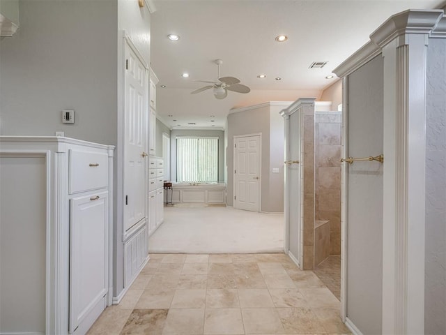corridor with visible vents, light tile patterned floors, light colored carpet, and recessed lighting