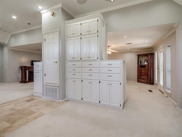 interior space with crown molding, recessed lighting, light colored carpet, and baseboards