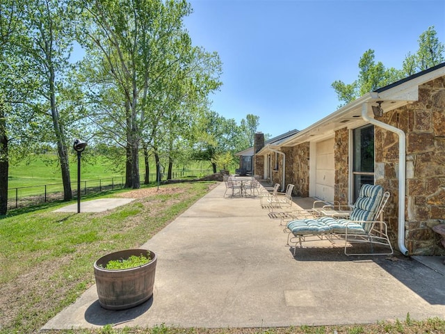 view of patio featuring fence