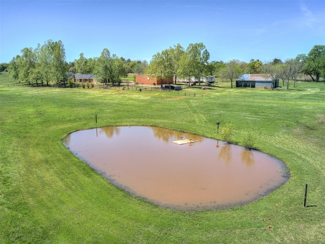 view of community with a lawn and a water view