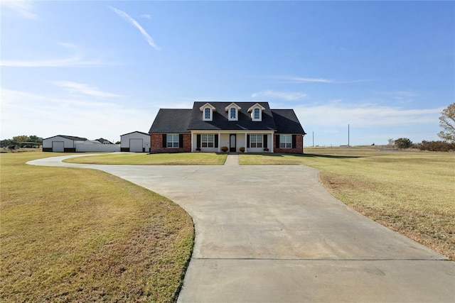 cape cod-style house with concrete driveway, a front lawn, and brick siding