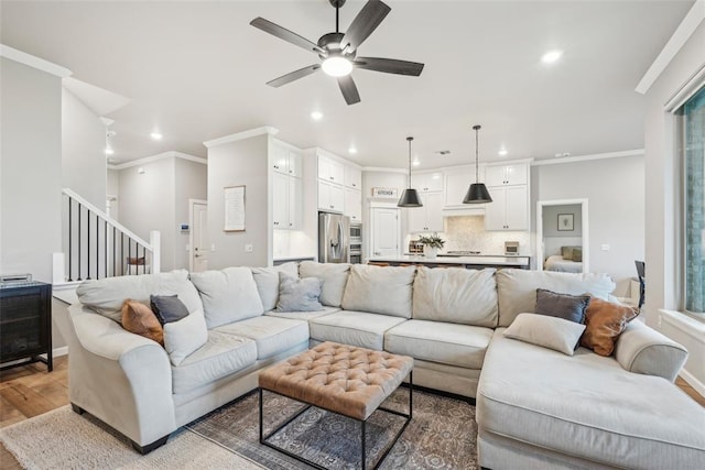 3320 Lola Ct, Moore, OK 73160 - living area featuring a ceiling fan, stairs, wood finished floors, ornamental molding, and recessed lighting
