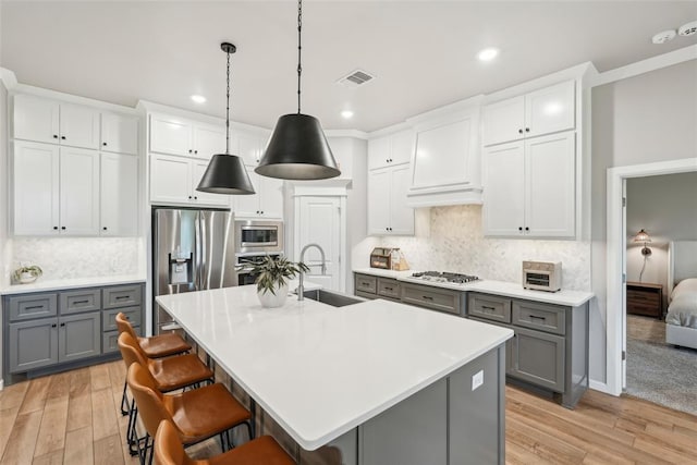 3320 Lola Ct, Moore, OK 73160 - kitchen featuring gray cabinetry, appliances with stainless steel finishes, a sink, and visible vents