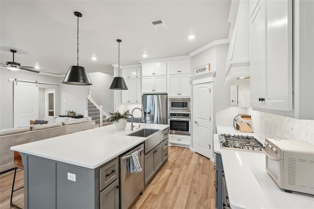 3320 Lola Ct, Moore, OK 73160 - kitchen with visible vents, white cabinets, a sink, appliances with stainless steel finishes, and gray cabinetry