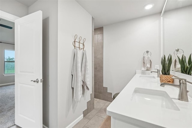 3320 Lola Ct, Moore, OK 73160 - bathroom with a sink, tile patterned floors, a tile shower, and double vanity