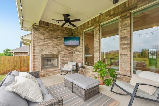 3320 Lola Ct, Moore, OK 73160 - view of patio featuring fence, a ceiling fan, and an outdoor living space with a fireplace