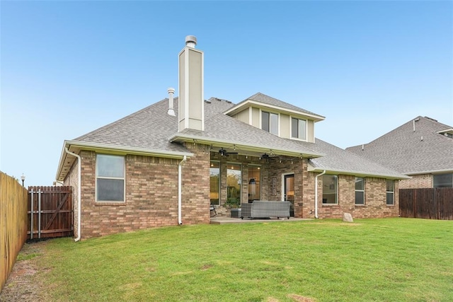 3320 Lola Ct, Moore, OK 73160 - rear view of property with a chimney, roof with shingles, a lawn, a patio area, and a fenced backyard