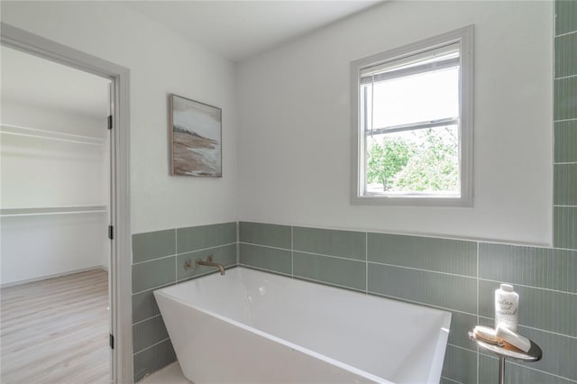 3224 NW 47th St, Oklahoma City, OK 73112 - full bathroom with tile walls and a freestanding tub