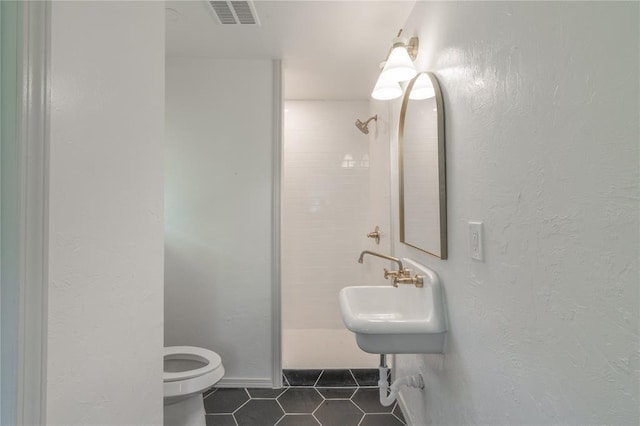 3224 NW 47th St, Oklahoma City, OK 73112 - bathroom featuring visible vents, toilet, tile patterned flooring, and a sink