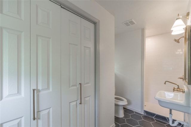 3224 NW 47th St, Oklahoma City, OK 73112 - bathroom with visible vents, toilet, tile patterned flooring, and a closet