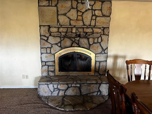 details with carpet floors, baseboards, and a stone fireplace