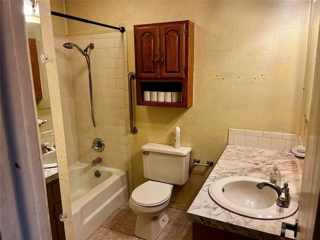 full bathroom with a textured wall, tile patterned flooring, vanity, toilet, and shower / washtub combination