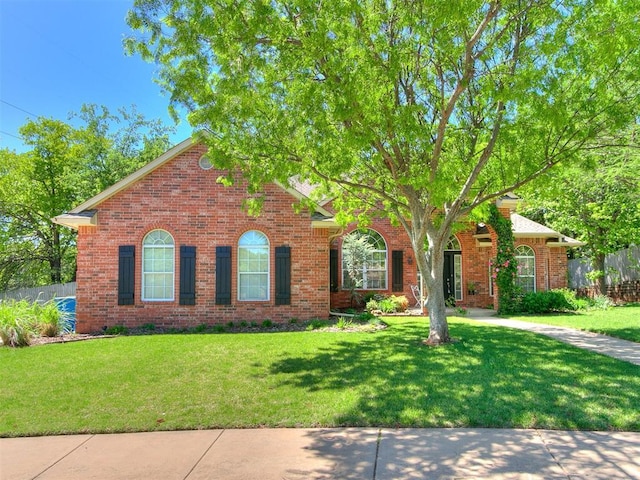 3401 Kentucky Way, Edmond, OK 73034 - view of front facade featuring brick siding, a front lawn, and fence