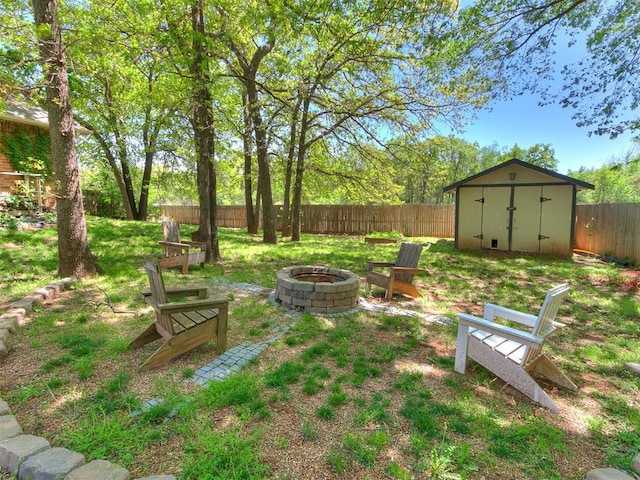 3401 Kentucky Way, Edmond, OK 73034 - view of yard featuring an outdoor structure, a storage unit, a fenced backyard, and an outdoor fire pit