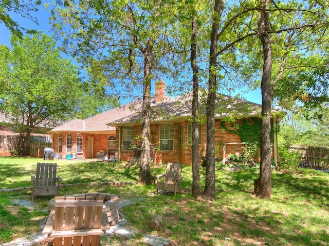 3401 Kentucky Way, Edmond, OK 73034 - back of house featuring a chimney, brick siding, fence, and a yard