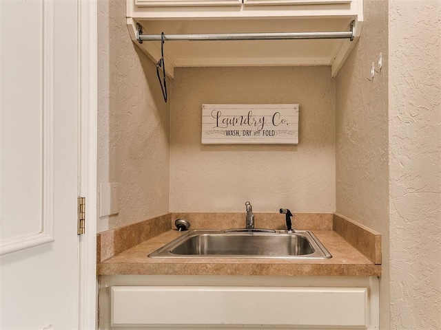3401 Kentucky Way, Edmond, OK 73034 - washroom with a textured wall and a sink