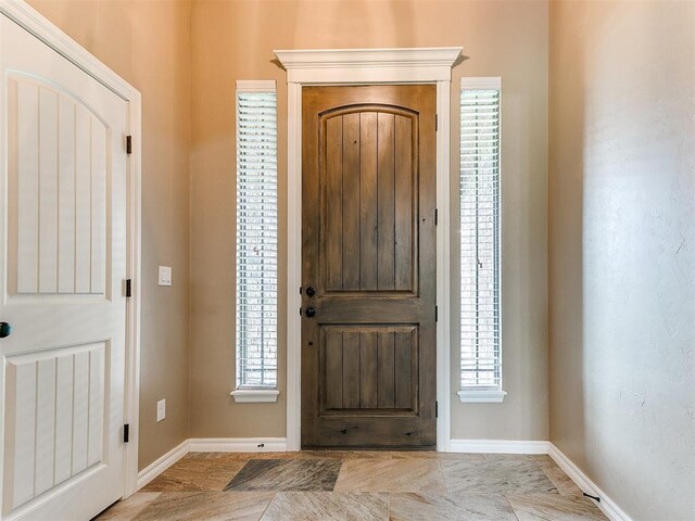 entryway with baseboards and plenty of natural light