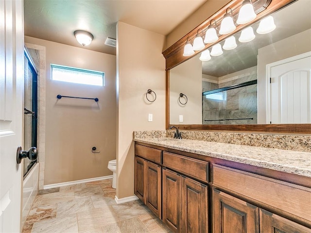 bathroom featuring visible vents, baseboards, bath / shower combo with glass door, vanity, and toilet