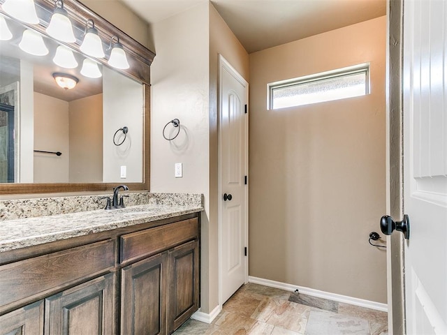 full bathroom featuring vanity and baseboards
