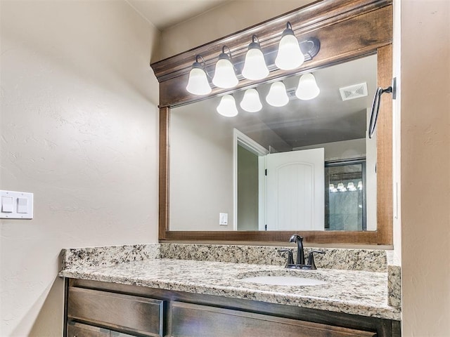 bathroom with visible vents and vanity
