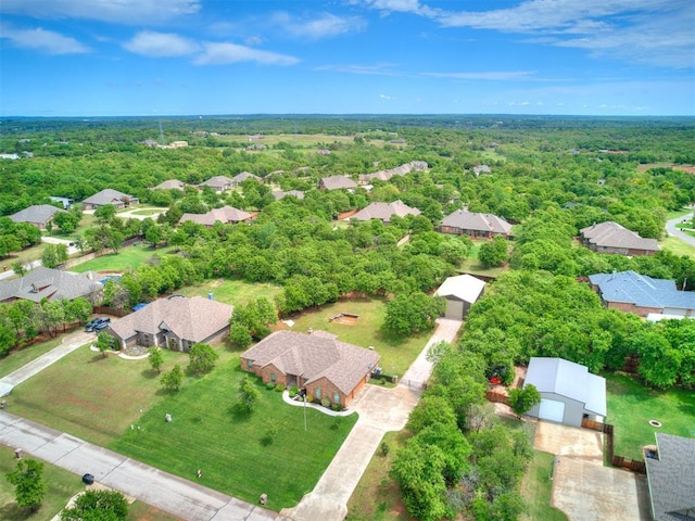 bird's eye view featuring a wooded view and a residential view