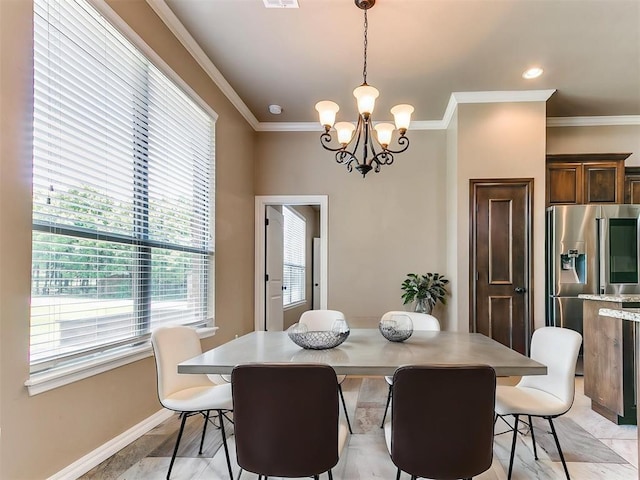 dining room with baseboards, ornamental molding, a notable chandelier, and visible vents