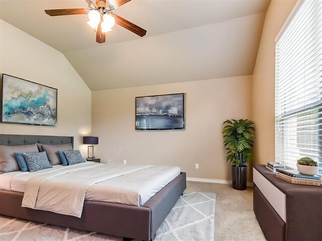 bedroom with baseboards, ceiling fan, light colored carpet, and lofted ceiling
