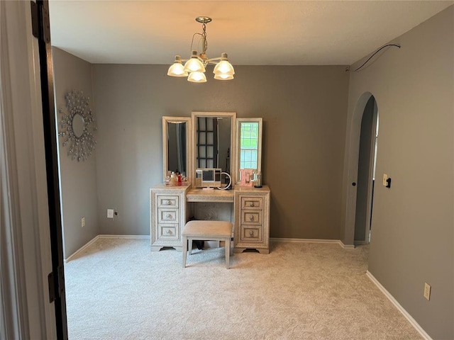 dining area featuring arched walkways, baseboards, light colored carpet, and an inviting chandelier