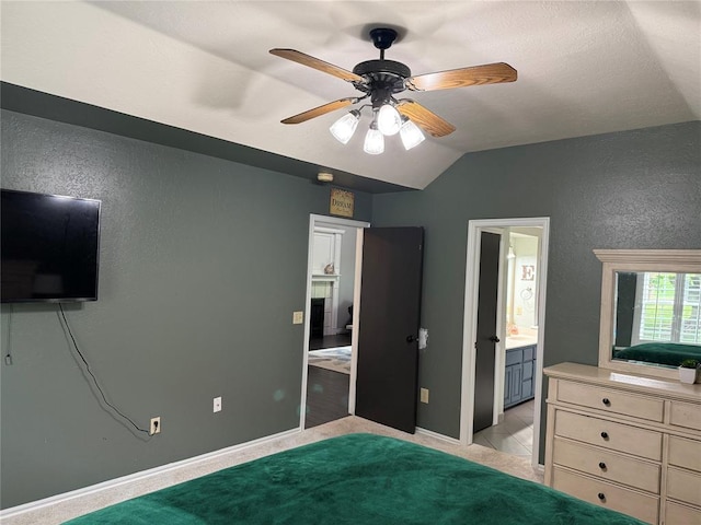 unfurnished bedroom featuring baseboards, a textured wall, ceiling fan, and lofted ceiling