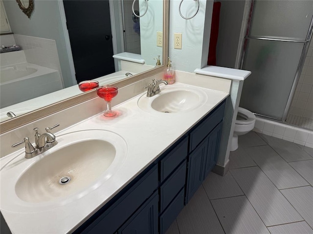 full bathroom with toilet, a shower stall, a sink, and tile patterned flooring