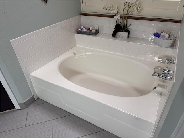 full bath with tile patterned floors and a bath