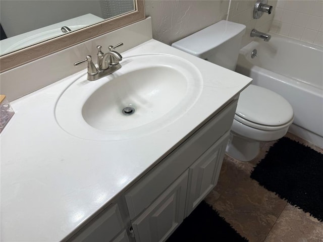 full bathroom with toilet and vanity