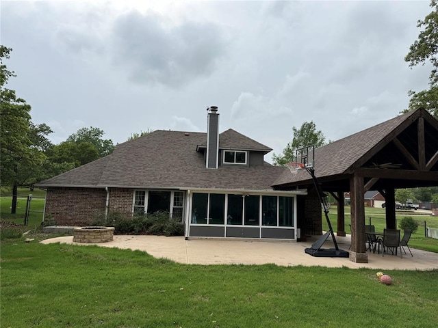 rear view of house with a lawn, a gazebo, a chimney, and roof with shingles