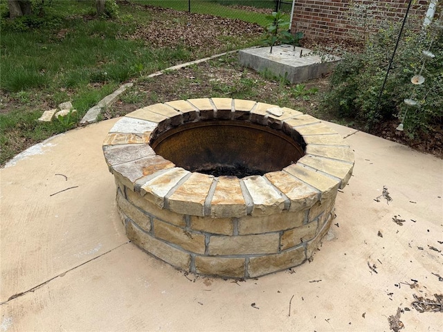 exterior details featuring an outdoor fire pit and fence
