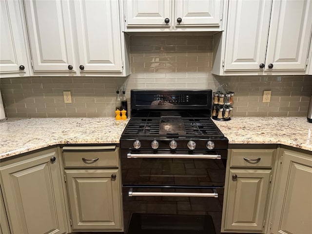 7900 Double Springs Dr, Oklahoma City, OK 73150 - kitchen featuring black gas stove, decorative backsplash, and white cabinetry