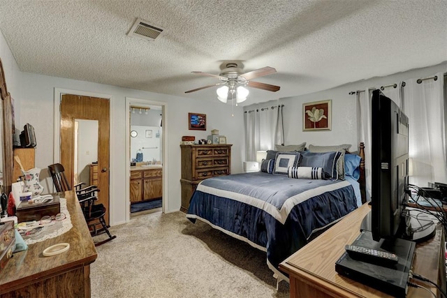 bedroom featuring ceiling fan, a textured ceiling, visible vents, a sink, and light carpet