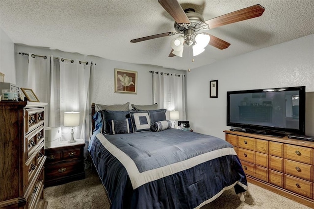 bedroom with carpet floors, ceiling fan, and a textured ceiling
