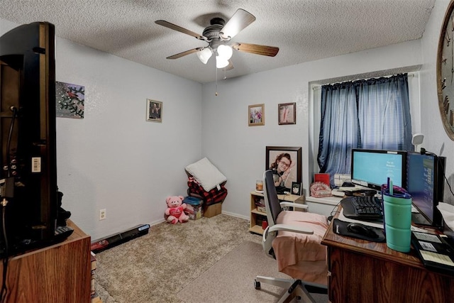 home office featuring carpet flooring, a textured ceiling, ceiling fan, and baseboards