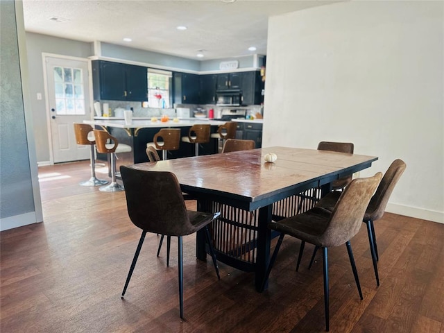 dining area featuring baseboards, dark wood-style floors, and recessed lighting