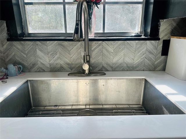 details with a sink and backsplash