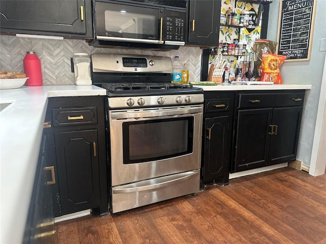 kitchen with backsplash, black microwave, dark wood-style flooring, and stainless steel gas stove